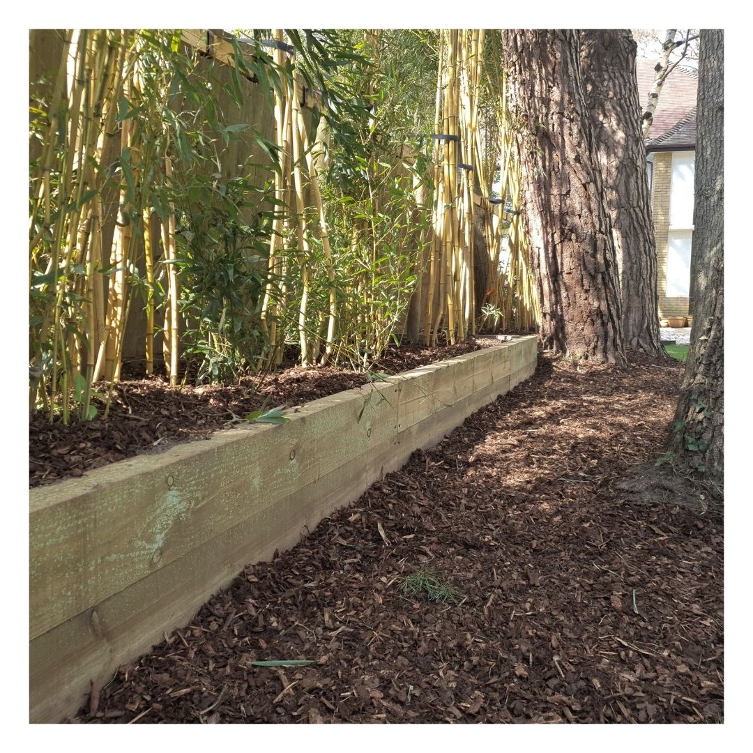 Eco Bark Nuggets in a garden border with plants