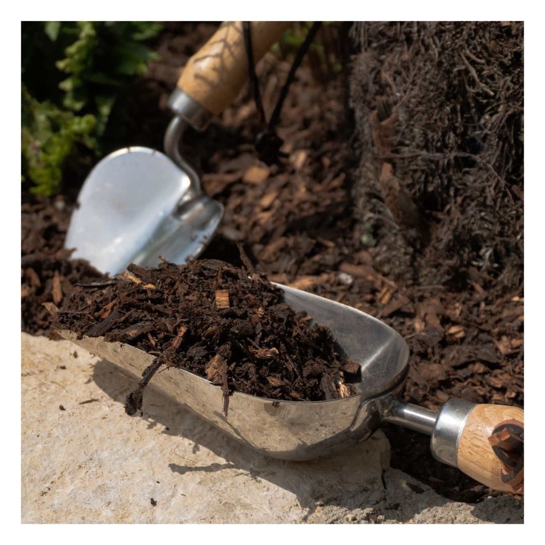 Eco organic mulch in a hand shovel