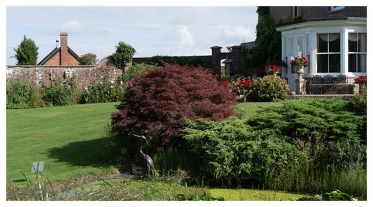 Image of large polished garden and manor house