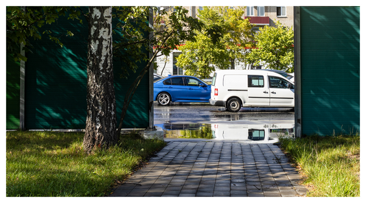 a busy road outside of a house garden