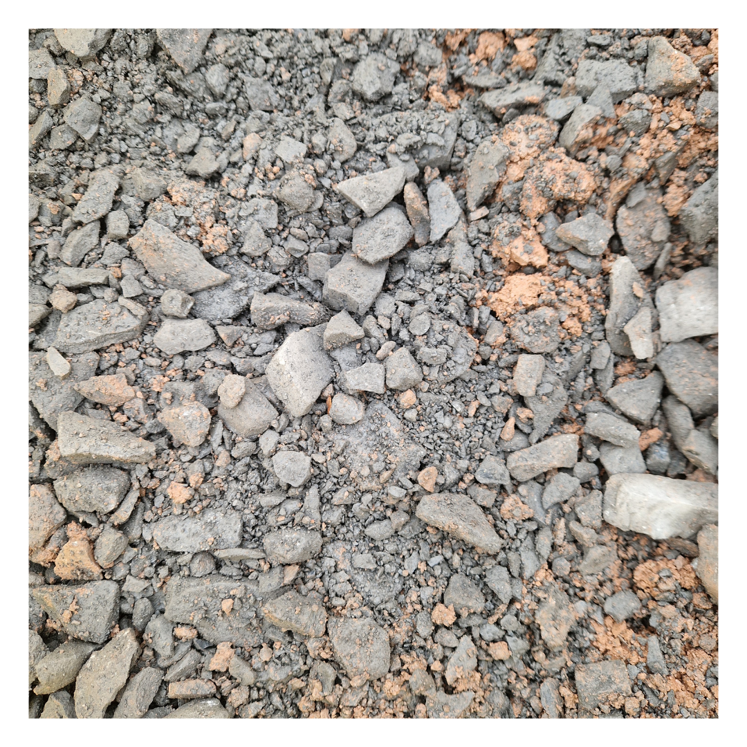 Close-up image of 40mm scalpings, a mix of crushed stone and fine materials, commonly used as a durable sub-base for paths, driveways, and patios in landscaping projects.