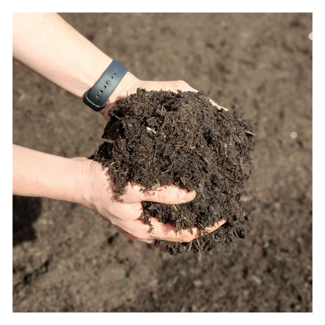 Hands holding Eco Soil Improving Mulch