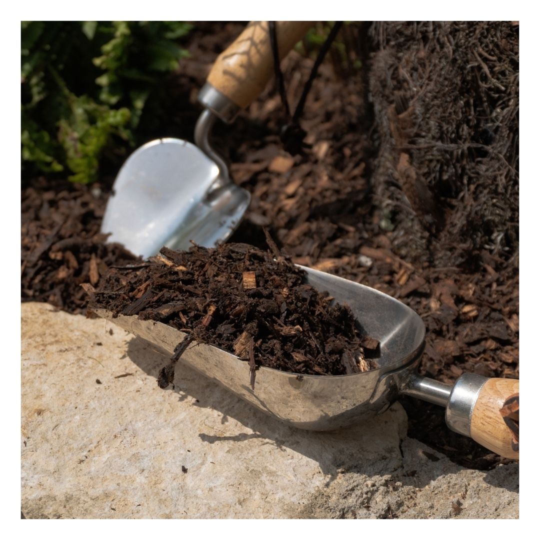 Eco Woodland Garden Mulch in a hand shovel